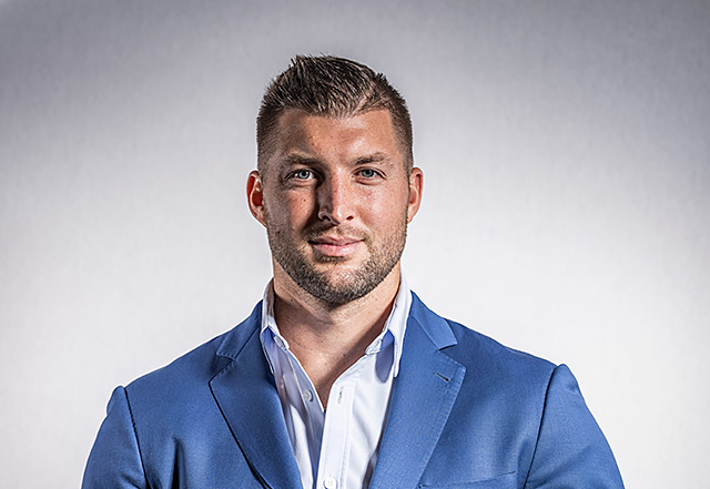 Tim Tebow wearing a blue suit| Tim Tebow